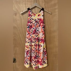 Women’s Dress, multicolored with shoulder straps crisscrossing in back.